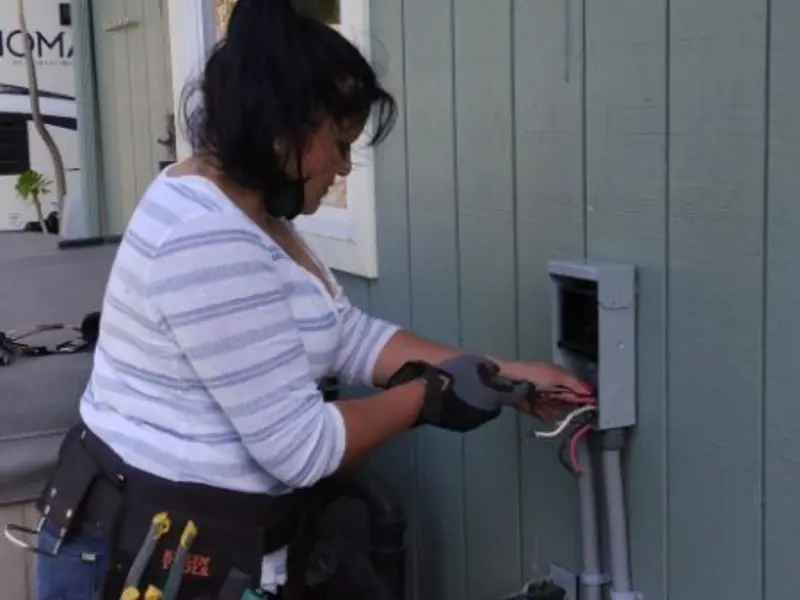 Licensed electrician wiring an exterior subpanel in Palmyra